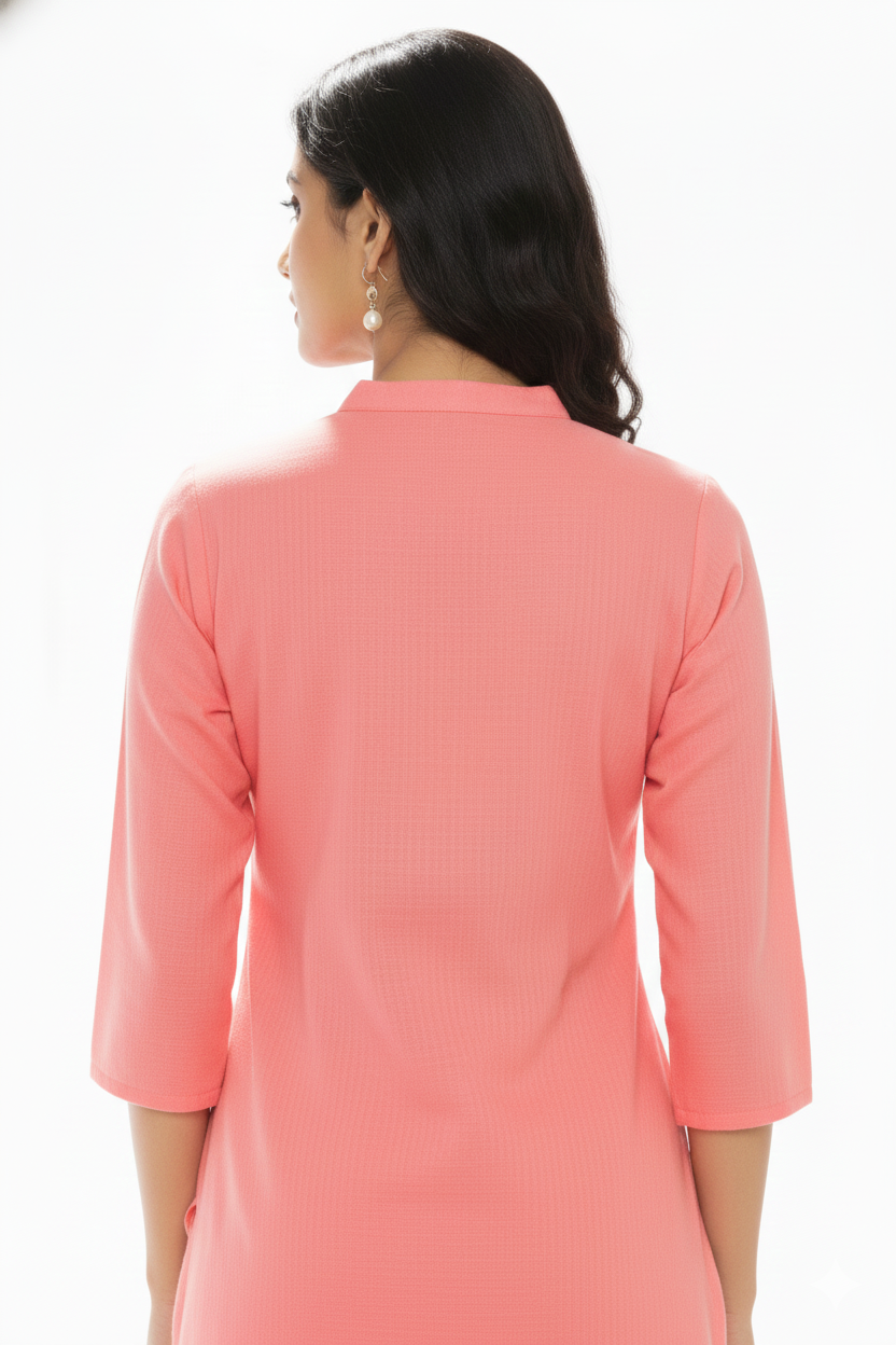 Woman wearing a coral pink kurta against a white background